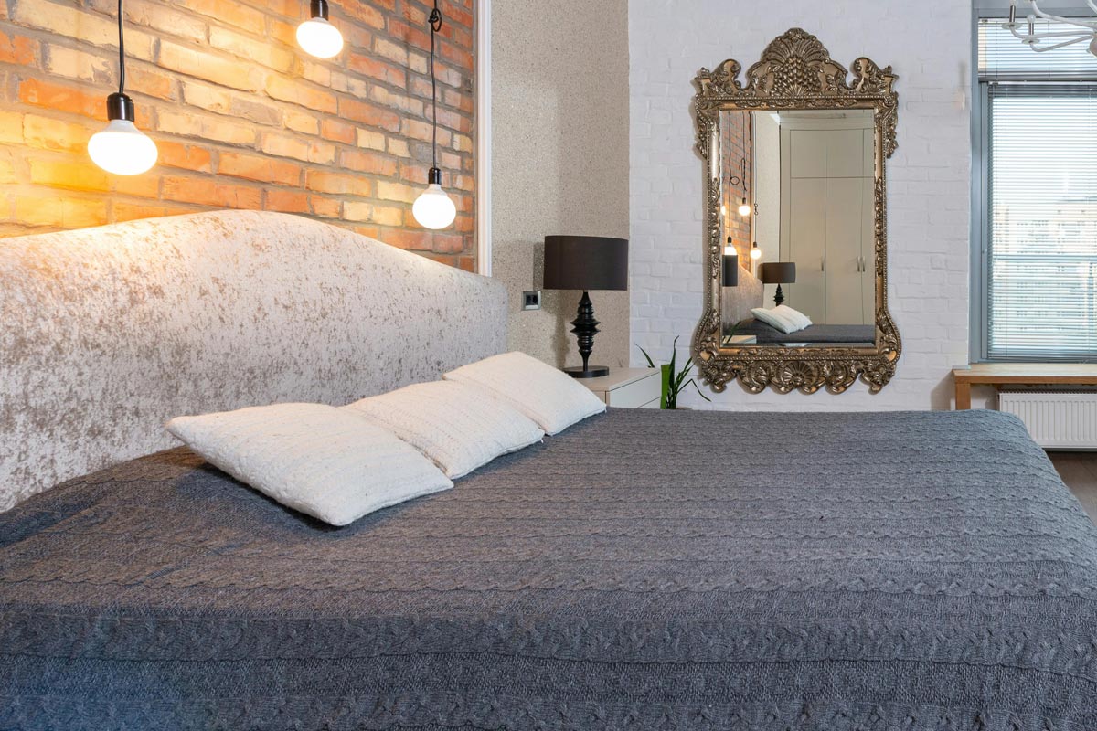 A bedroom with a large mirror
